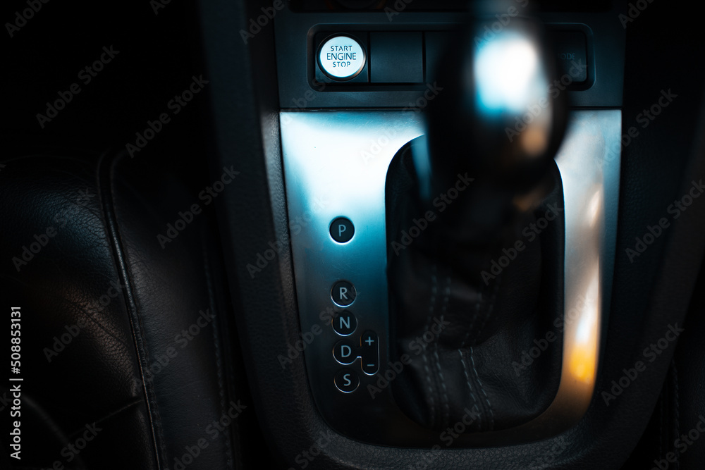 Close-up top view of automatic gearbox selector. Dark photo. Close-up top view of automatic gearbox selector. Dark photo.