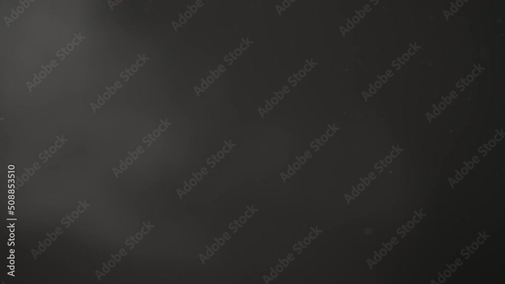 Slow motion shot of real dust particles in air with back light over black background Slow motion shot of real dust particles in air with back light over black background