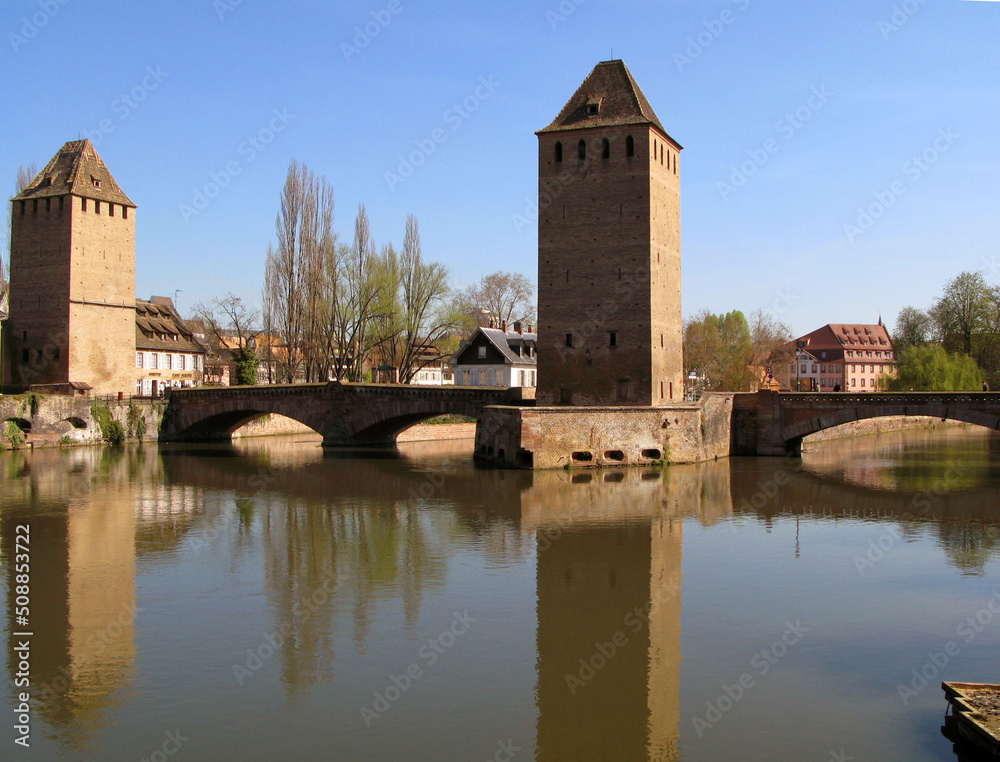 View of the fortress of Strasbourg and the river Ile, reflection in the water, spring, blossoming trees, old houses, April, spring, France, 2009