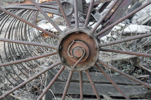 Old round rusty wheel agricultural machinery. Steampunk spokes. High quality photo