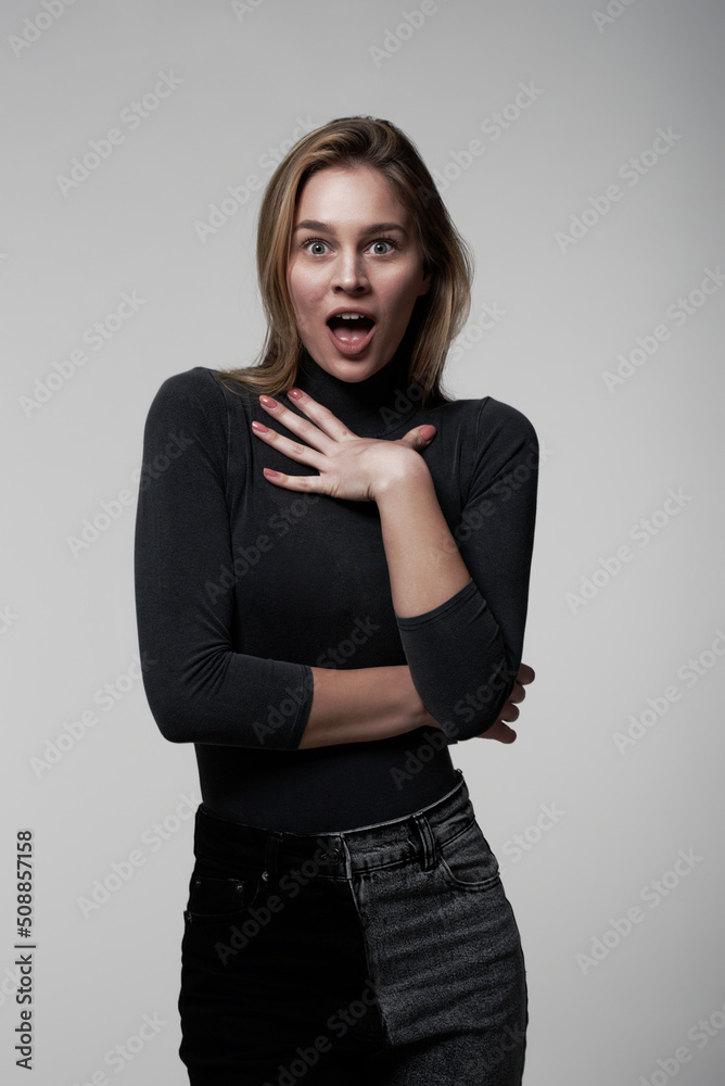 A young and beautiful brunette posing on a white background, shocked A young and beautiful brunette posing on a white background, shocked