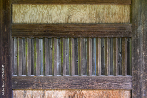 Closeup of weathered rustic wooden doors, as a background
