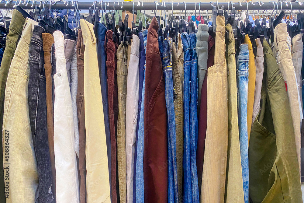 Lots of colorful trousers hanging on a hanger