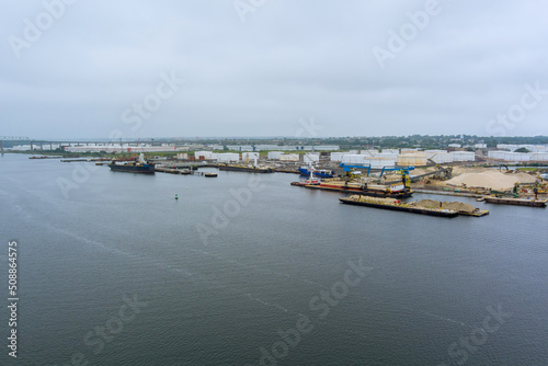 Aerial top view the oil tanker ship platforms with unloading at port near oil storage