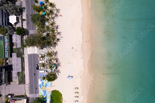 Aerial view top down of Coconut palm trees on the beautiful patong beach Phuket Thailand Amazing sea beach sand tourist travel destination in the andaman sea Beautiful island