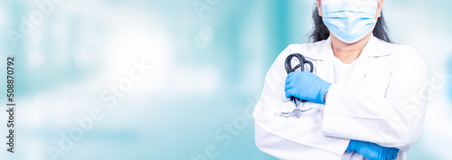Fototapeta Naklejka Na Ścianę i Meble -  Woman doctor stands in front of an examination room in a hospital. concept of medical treatment health care annual health check Beauty, Research, Lab, Science, closeup, copy space, blurred background