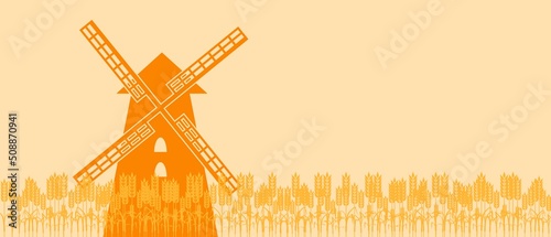 Summer landscape with a field of ripe wheat and old windmill