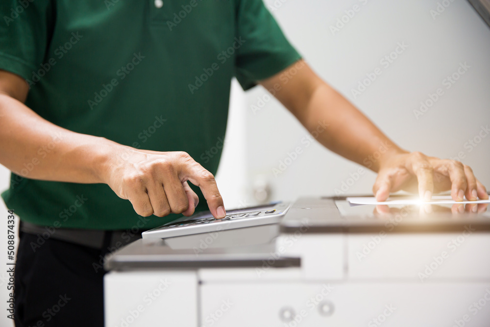 Copier printer, Close up hand office man press copy button on panel to using the photocopier or photocopy machine for scanning document printing a sheet paper and xerox photocopy. - obrazy, fototapety, plakaty 