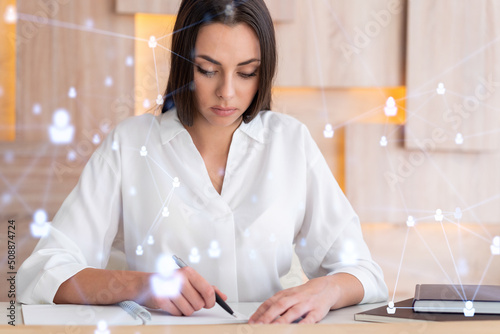 Portrait of attractive businesswoman working with documents and thinking how to protect clients confidential information and cyber security. IT hologram padlock icons over office background.