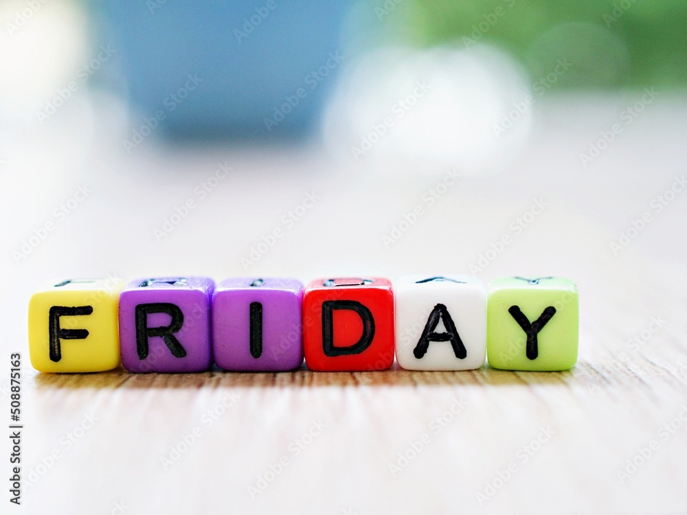 Alphabet 'Friday' beads in cube shape with blurred background, block ...