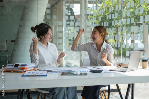 Marketing, Financial, Accounting, Planning, Businesswoman expressing joy that the company has profited from her team work. photo