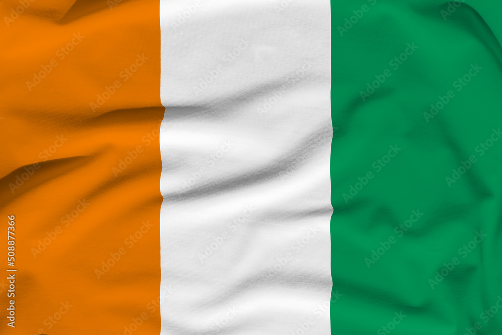 Ivory Coast national flag, folds and hard shadows on the canvas
