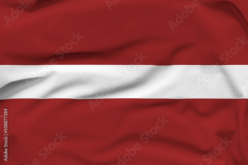 Latvia national flag, folds and hard shadows on the canvas