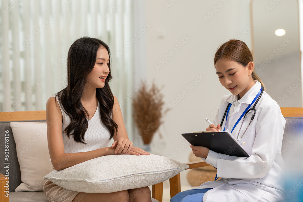 Asian doctor woman visited patient woman to diagnosis and check up health at home or private hospital. Female patient explain health problem and symptoms to doctor .Health care premium service at home Asian doctor woman visited patient woman to diagnosis and check up health at home or private hospital. Female patient explain health problem and symptoms to doctor .Health care premium service at home