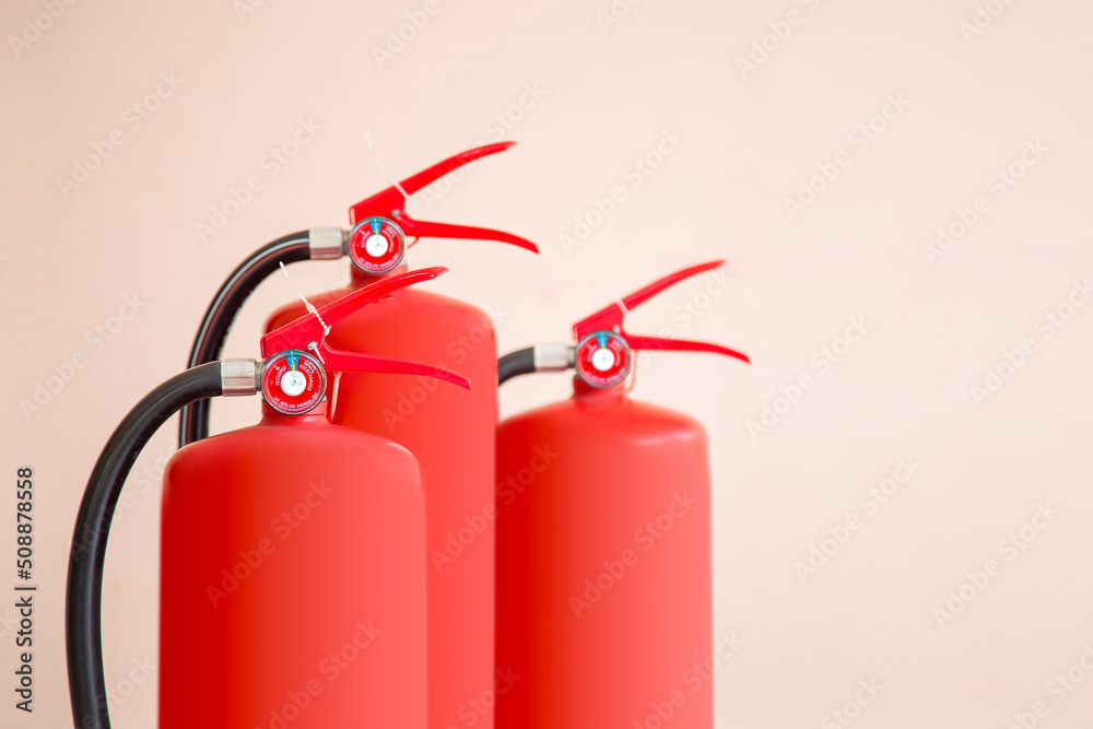 Obraz premium Close up fire extinguisher and firefighter checking pressure gauge level for protection and prevent and safety rescue and use of equipment on fire training concept.