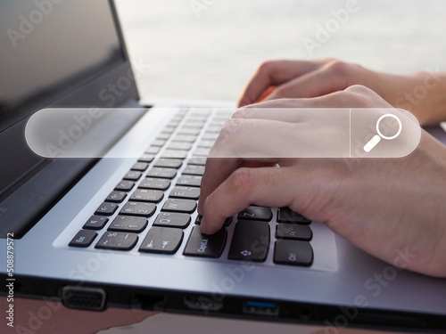 A businessman uses his laptop to search the Internet for information.