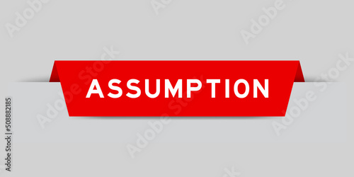 Red color inserted label with word assumption on gray background