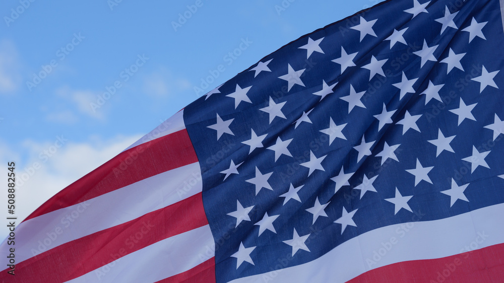America flag waving in blue sky close up. Memorial Day, 4th of July, Veterans Day, Independence Day, Celebrate USA and American Election concept. America flag waving in blue sky close up. Memorial Day, 4th of July, Veterans Day, Independence Day, Celebrate USA and American Election concept.