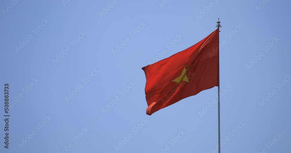 A vietnamese flag behind the blue sky long shot