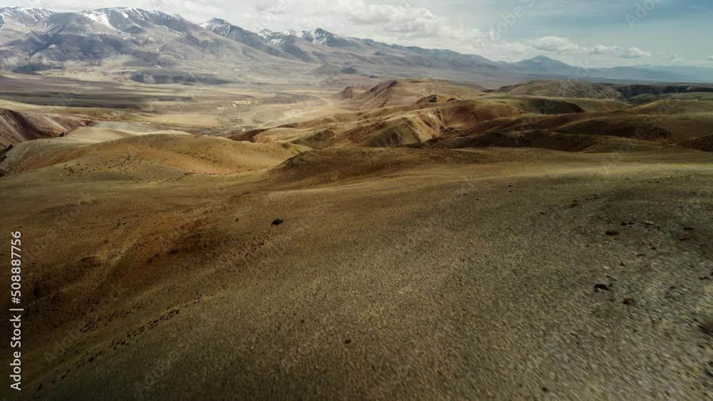 An epic mountain landscape. Snow covers the tops of the mountains. Bluish sky in the background. Mountains of different heights. Mountain valley from a low altitude. Aerial photography in 4K. An epic mountain landscape. Snow covers the tops of the mountains. Bluish sky in the background. Mountains of different heights. Mountain valley from a low altitude. Aerial photography in 4K.
