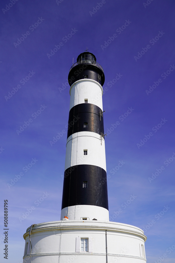 Phare de Chassiron in Island D'Oleron in French Charente with stripedwhite black lighthouse in blue sky France
