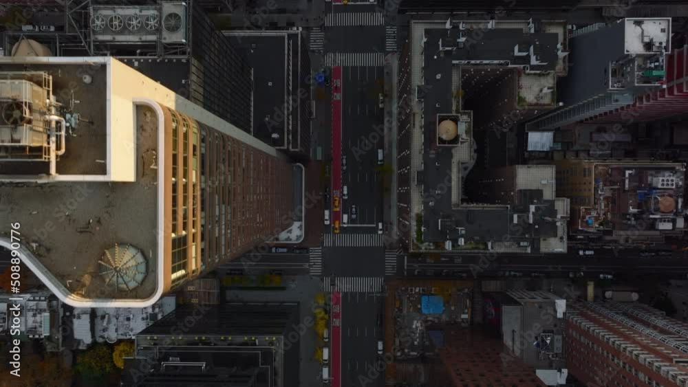 Aerial birds eye overhead top down view of cars driving in streets of downtown. Fly above high rise buildings. Manhattan, New York City, USA Aerial birds eye overhead top down view of cars driving in streets of downtown. Fly above high rise buildings. Manhattan, New York City, USA