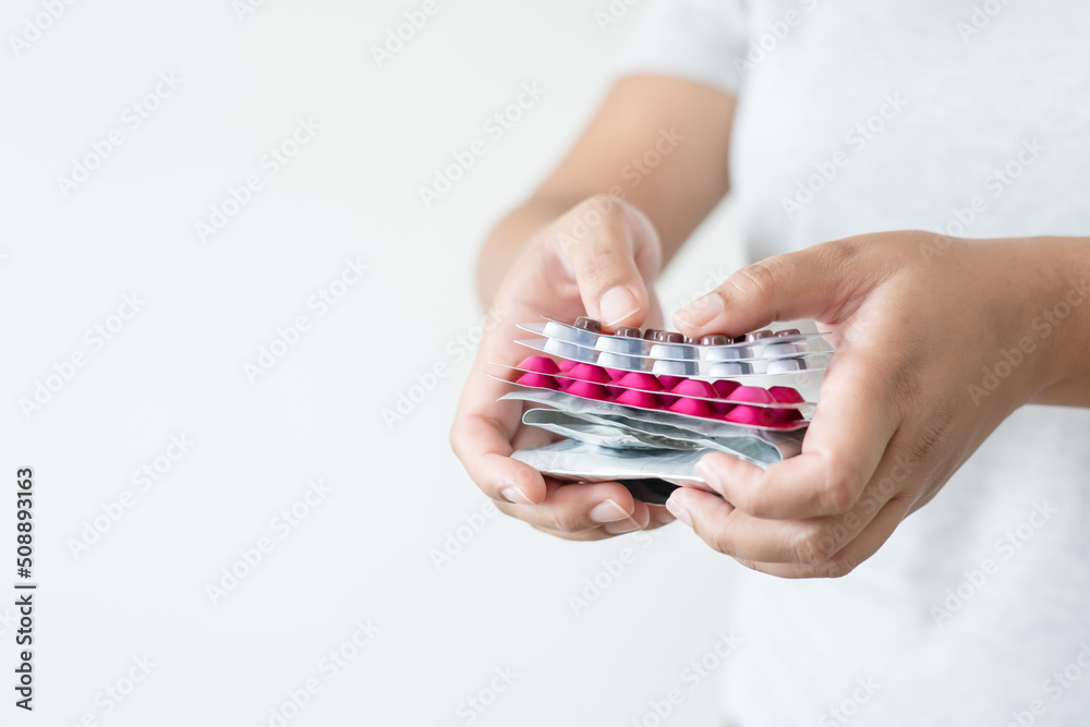 Many colorful pills in woman hand. Concept of medicine and supplement in hospital and medical business. Many colorful pills in woman hand. Concept of medicine and supplement in hospital and medical business.