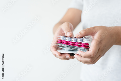 Many colorful pills in woman hand. Concept of medicine and supplement in hospital and medical business.