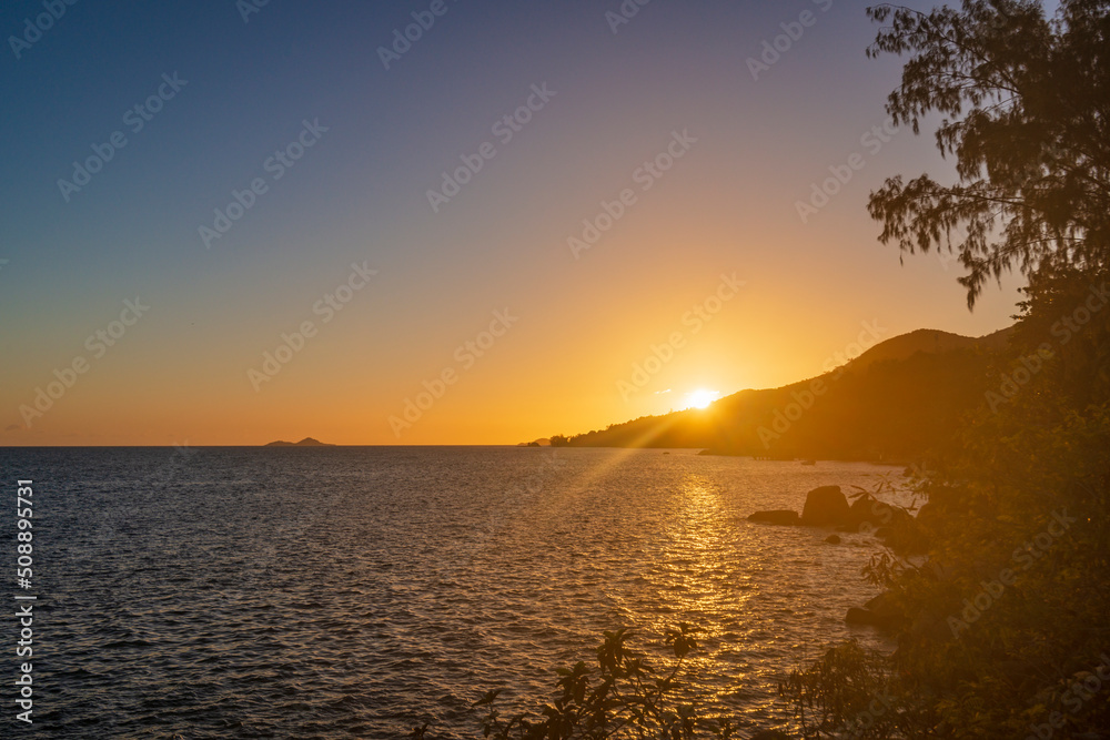 Sunset view from the coast on Anse Bateau on Praslin island in Seychelles