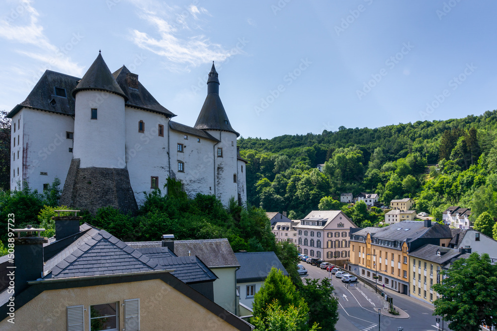 view of the picturesque and historic city center of Clervaux with castle and church in northern Luxembourg