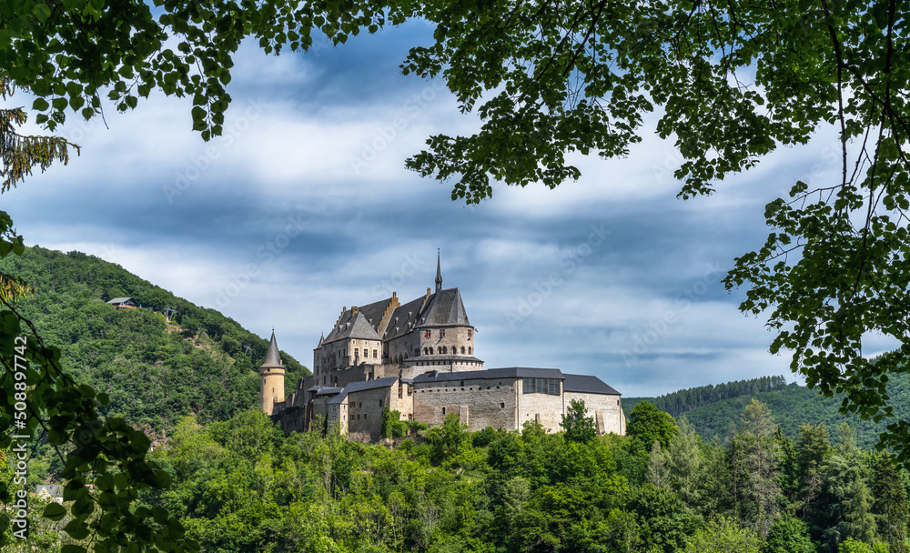 the historic Vianden Castle in Luxembourg framed by lush green summer forest the historic Vianden Castle in Luxembourg framed by lush green summer forest