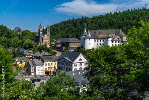 view of the picturesque and historic city center of Clervaux with castle and church in northern Luxembourg