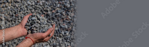 Crushed stones in the hands of a man. Selective focus. photo