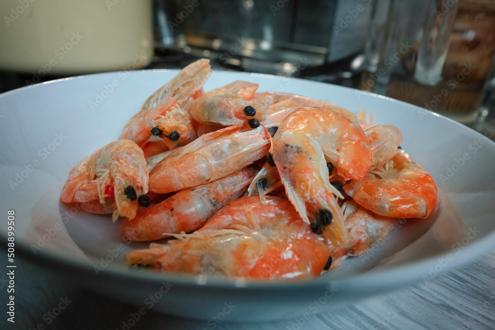 Fried king prawns in a white plate in the kitchen