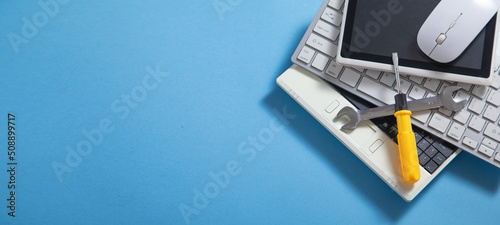 Bild auf Leinwand Wrench and screwdriver with a computer keyboard, tablet, mouse