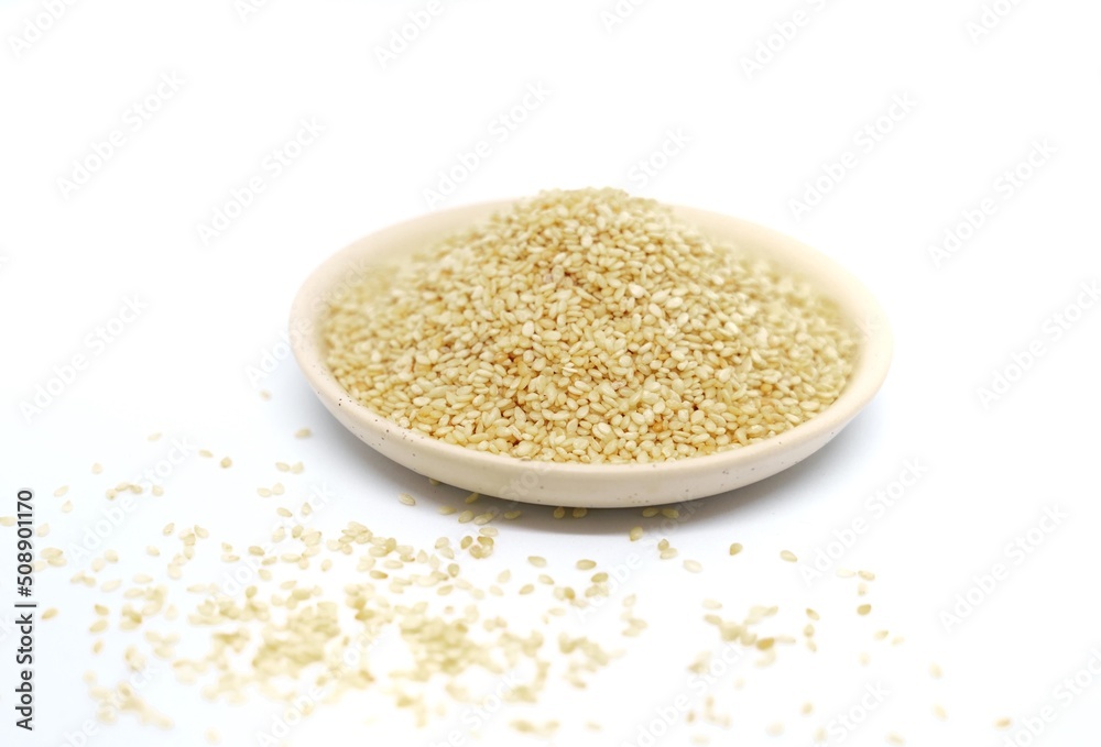 white sesame seeds in a plate on a white background white sesame seeds in a plate on a white background