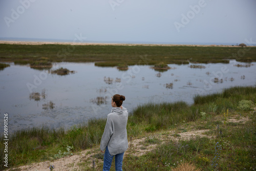 woman in sweater outdoors cloudy weather landscape