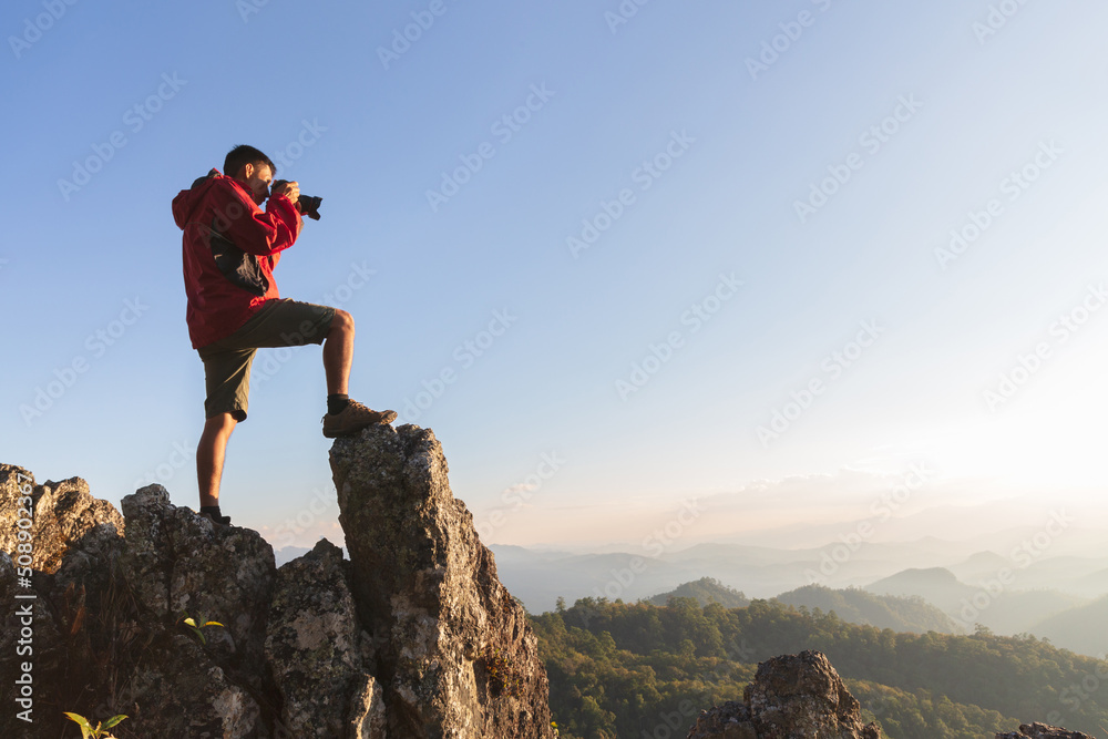 Happy people taking pictures of mountain scenery