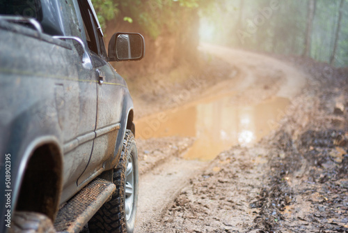 Muddy off-road vehicles, off road trip on mountain road sunset beautiful nature