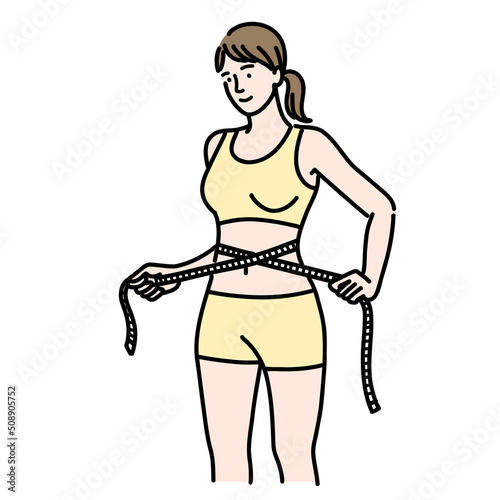 メジャーをお腹に当てているスタイルの良い若い女性