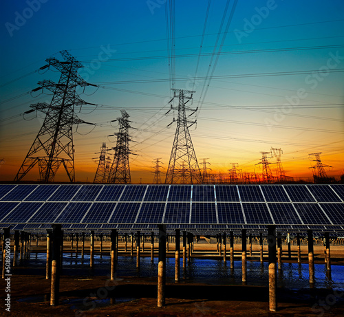 Solar panels and electric tower, green energy photo