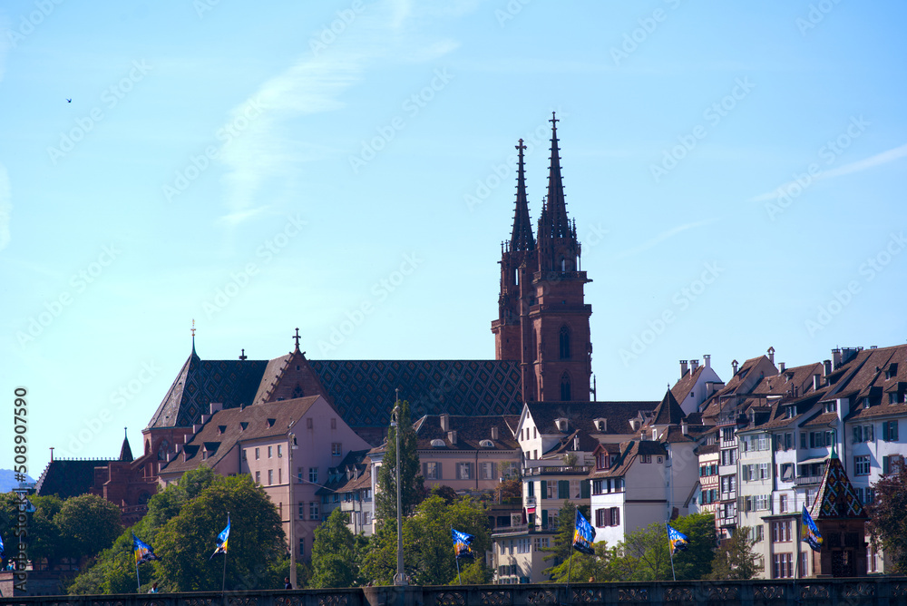Skyline of the old town of Basel with Basler Minster on a blue cloud spring day. Photo taken May 11th, 2022, Basel, Switzerland.