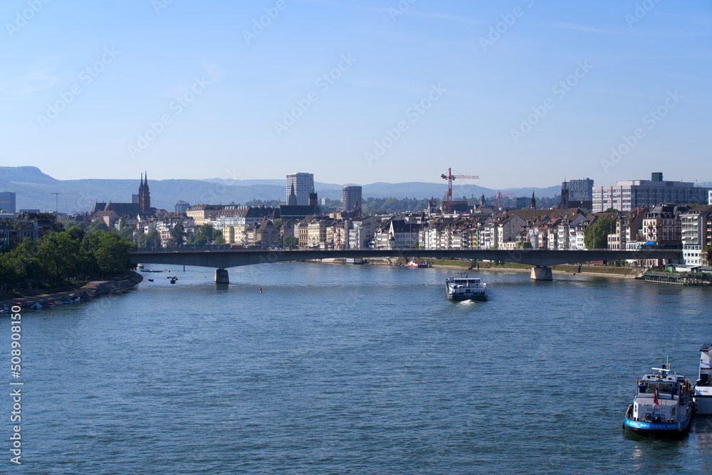 Cargo ship named on Rhine River at City of Basel on a sunny spring day. Photo taken May 11th, 2022, Basel, Switzerland.