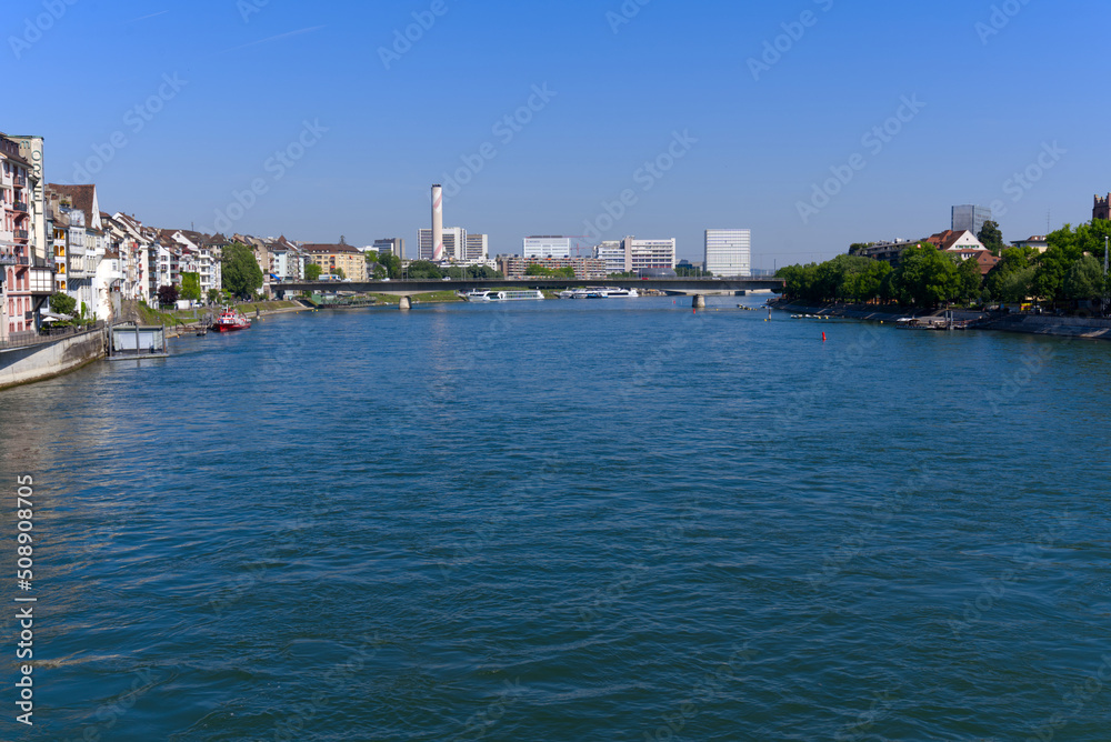 Rhine River at City of Basel with Johanniter Bridge in the background on a sunny spring day. Photo taken May 11th, 2022, Basel, Switzerland.