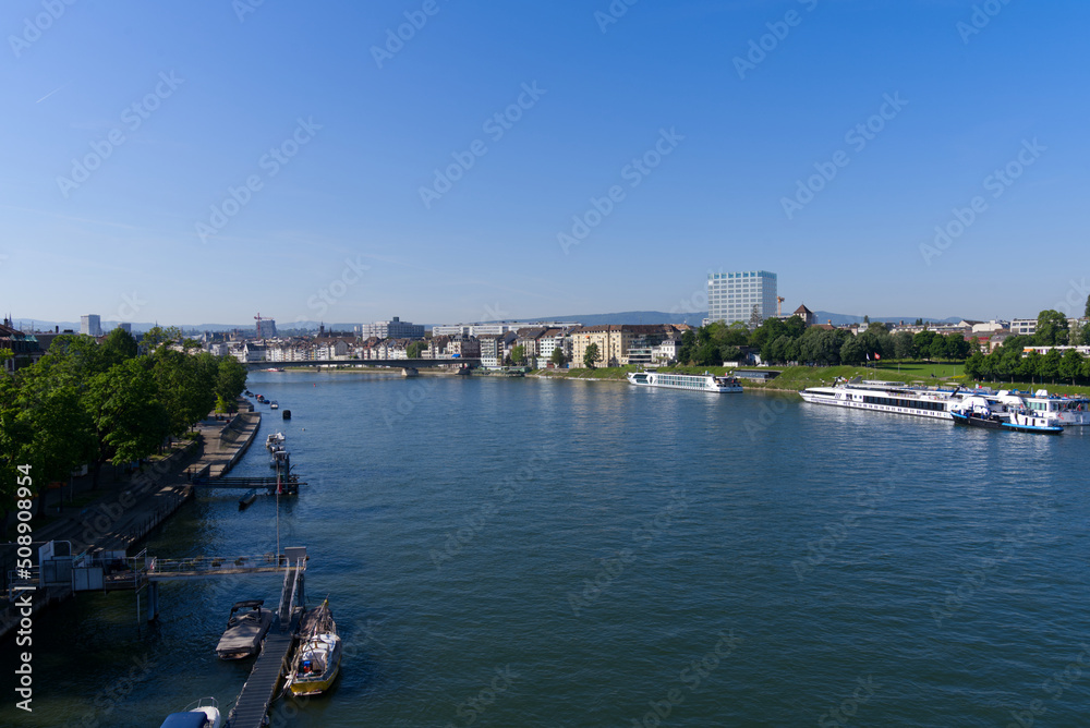 Aerial view over Rhine River with skyline of City of Basel on a sunny spring day. Photo taken May 11th, 2022, Basel, Switzerland.