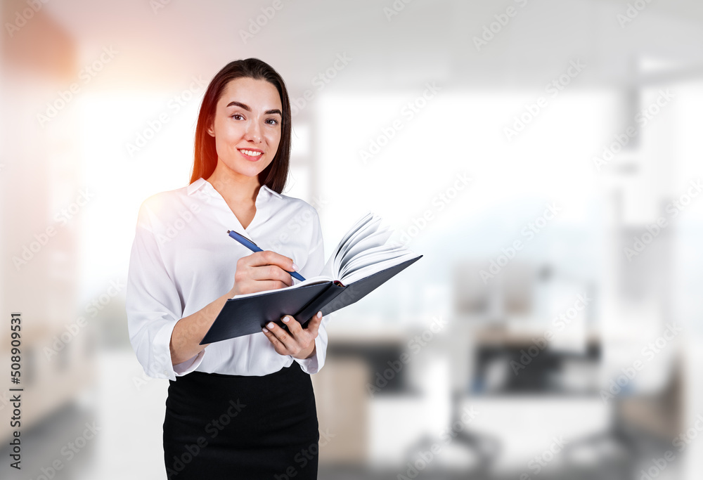 Businesswoman take note with notebook in hand, office room Businesswoman take note with notebook in hand, office room