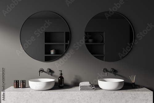 Grey bathroom interior with sink and mirror, accessories on deck