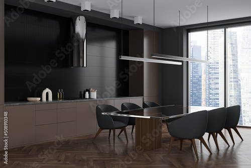 Dark kitchen interior with table and chairs, kitchenware and panoramic window