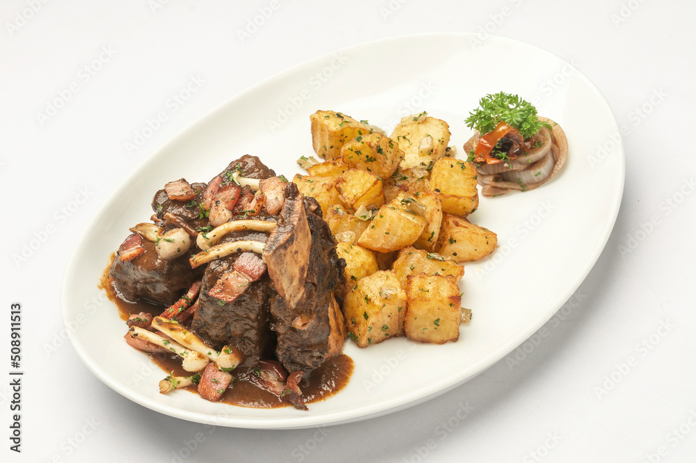 stewed beef short ribs and mushrooms in gravy with roast potatoes stewed beef short ribs and mushrooms in gravy with roast potatoes