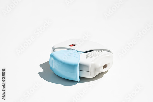 Asthma inhaler on white table. Aerosol for inhalation for treat lung inflammation and prevent asthma attack.